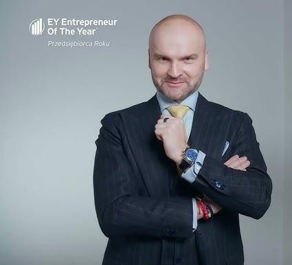 Obraz przedstawiający nowoczesne paczkomaty InPost w akcji, z ludźmi odbierającymi i nadającymi przesyłki, symbolizujący wygodę i efektywność innowacji Brzoski.